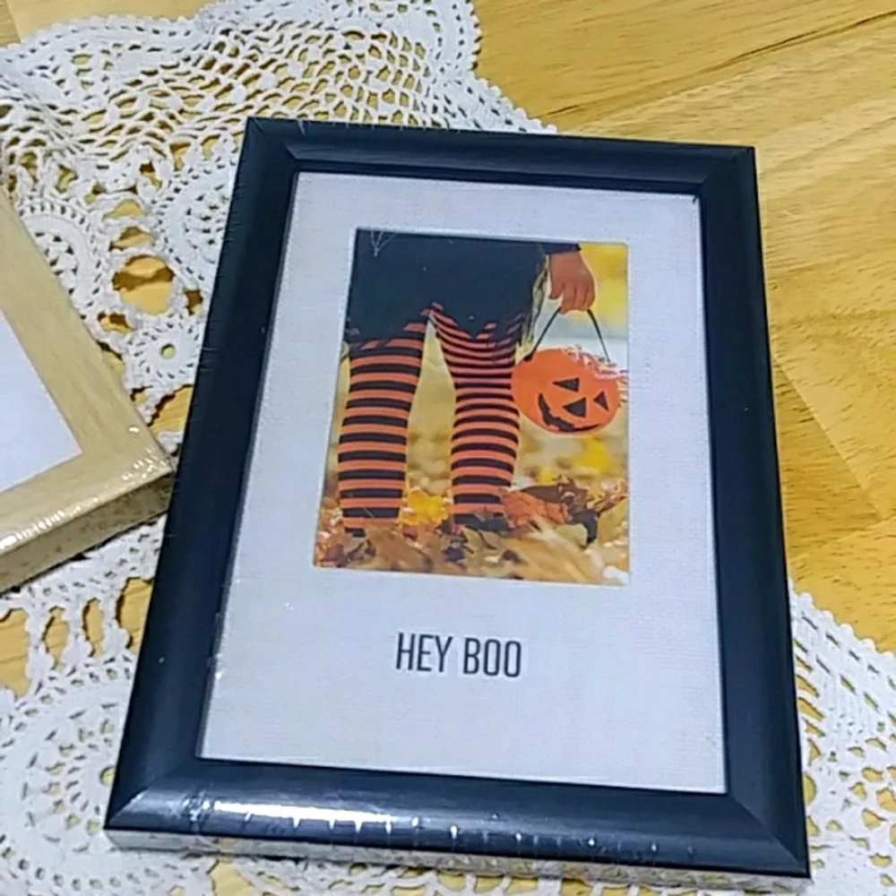 Three small picture frames, new in plastic